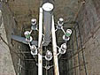 The bolt assembly is suspended into the form at grade level, ready for concrete, to complete the Carillon foundation. 